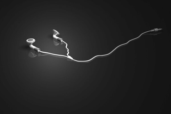 Los auriculares blancos se encuentran sobre un fondo gris espejado