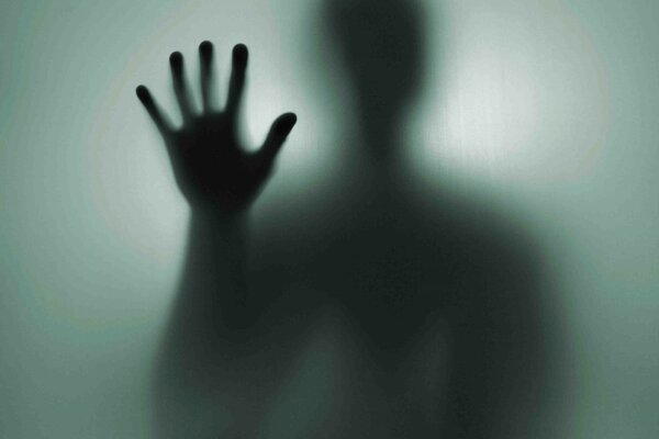 La mano de un extraño en la sombra