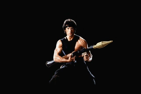 Sylvester Stallone como Rimbaud sobre un fondo negro con armas