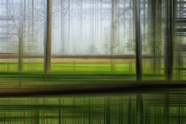 Vista abstracta de un campo verde y árboles en movimiento