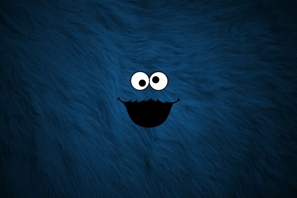 Lindo monstruo azul en un fondo peludo