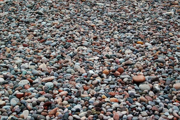 Muchas piedras pequeñas en la playa en el pueblo