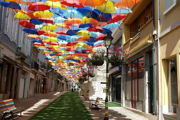 Verano Portugal. Calle rodeada de casas y paraguas