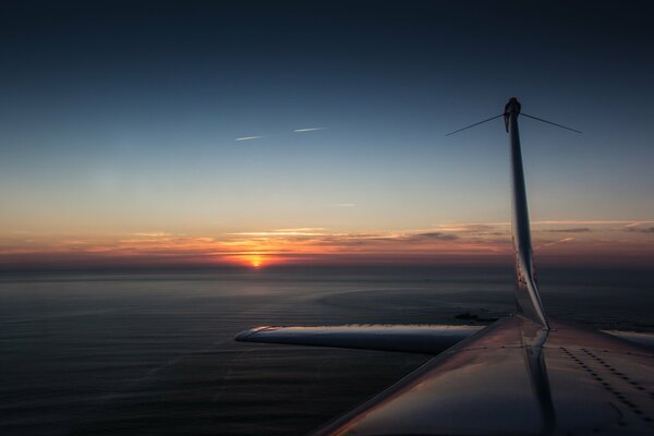 Puesta de sol cerca de la cola del avión
